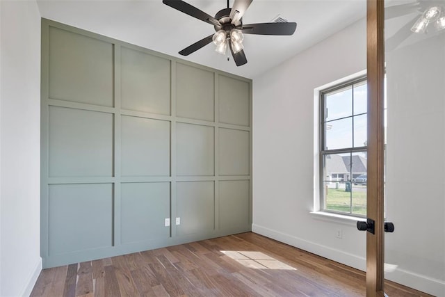 unfurnished bedroom featuring light hardwood / wood-style flooring, multiple windows, and ceiling fan