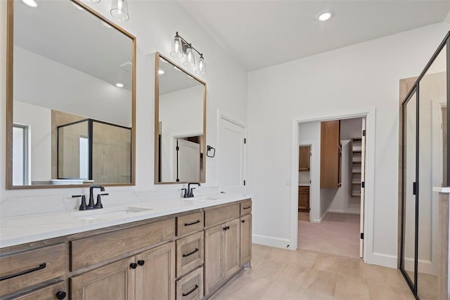 bathroom with vanity and a shower with door