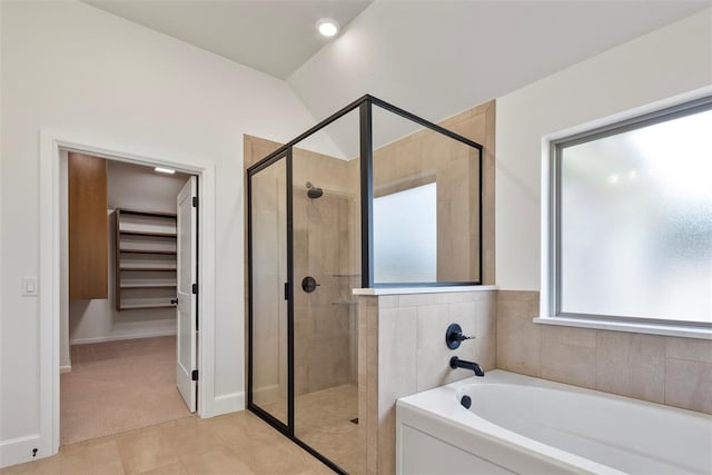 bathroom featuring tile patterned flooring, shower with separate bathtub, and lofted ceiling