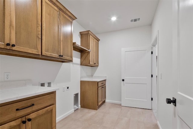 clothes washing area featuring hookup for a washing machine, cabinets, and hookup for an electric dryer