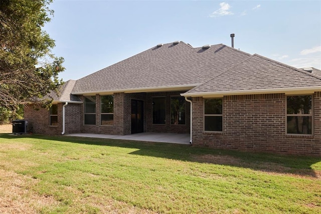 back of property featuring a lawn and a patio