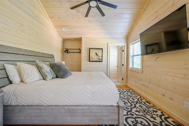 bedroom featuring ceiling fan, wood walls, wooden ceiling, and vaulted ceiling