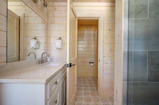 bathroom featuring vanity and wood walls