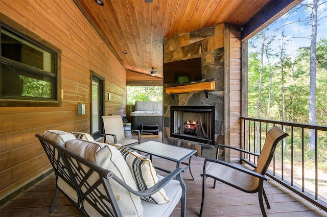 exterior space with an outdoor stone fireplace, a healthy amount of sunlight, lofted ceiling, and wood ceiling