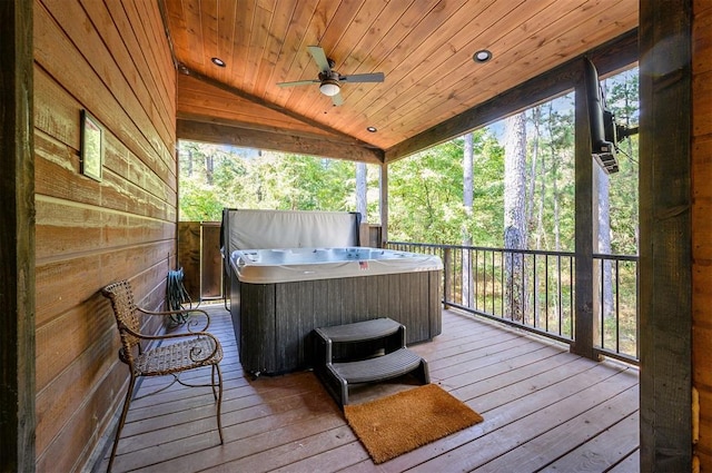 wooden terrace with ceiling fan and a hot tub