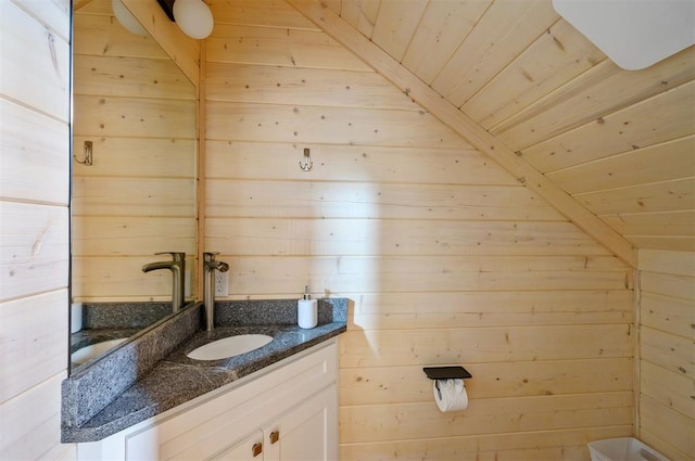 bathroom with wooden walls, vanity, wooden ceiling, and vaulted ceiling