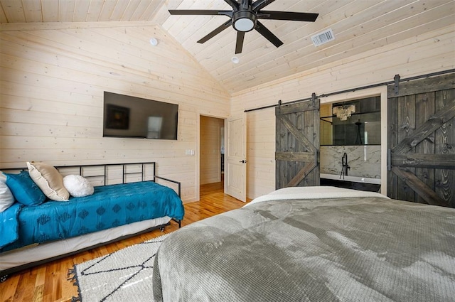 bedroom with wood-type flooring, a barn door, ceiling fan, and wooden ceiling