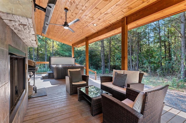 wooden deck featuring outdoor lounge area and ceiling fan