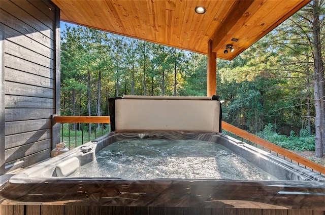 wooden deck featuring a hot tub