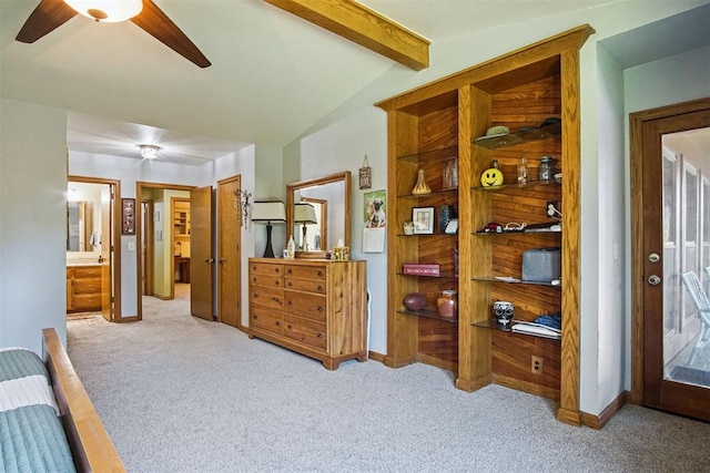 bedroom featuring vaulted ceiling with beams, ceiling fan, light carpet, and ensuite bath