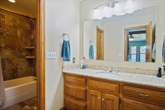 bathroom featuring ceiling fan, vanity, and shower / bath combo