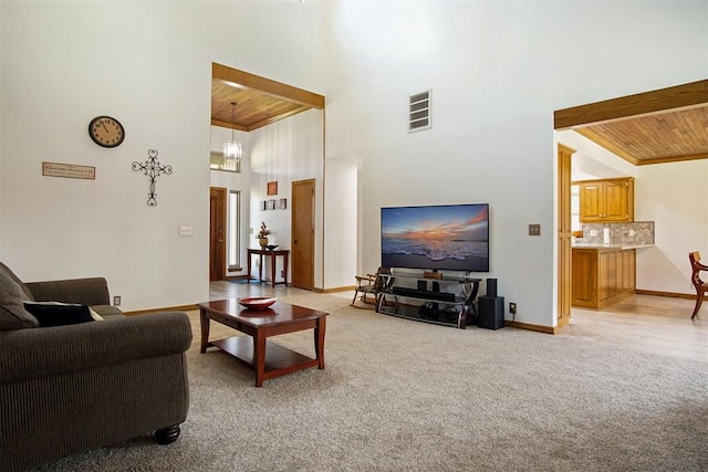 living room with wood ceiling, light carpet, a high ceiling, and a chandelier