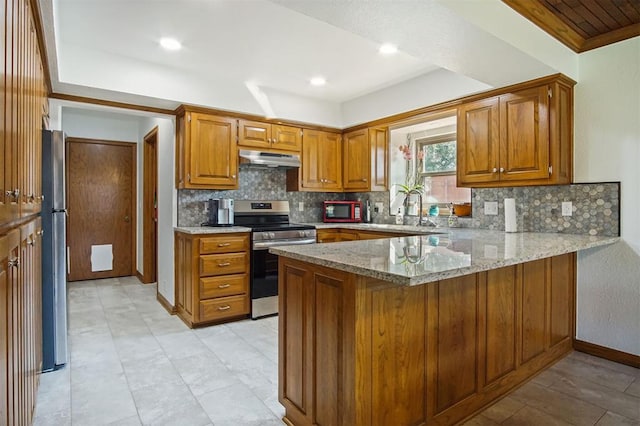 kitchen featuring backsplash, sink, appliances with stainless steel finishes, light stone counters, and kitchen peninsula