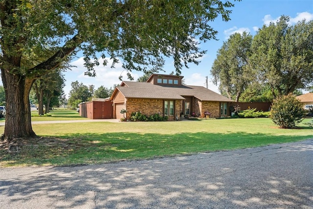 view of front of property with a garage and a front lawn