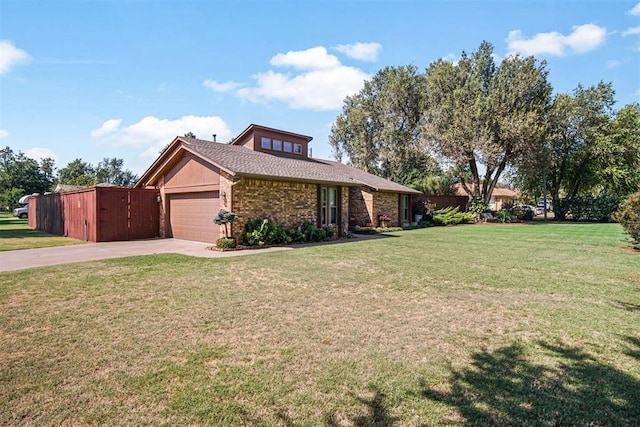 view of front of home with a front yard and a garage