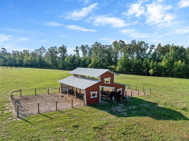 view of outdoor structure featuring a rural view and a yard