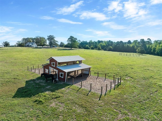 surrounding community with an outbuilding, a yard, and a rural view