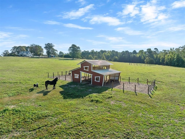 view of play area with an outbuilding and a rural view