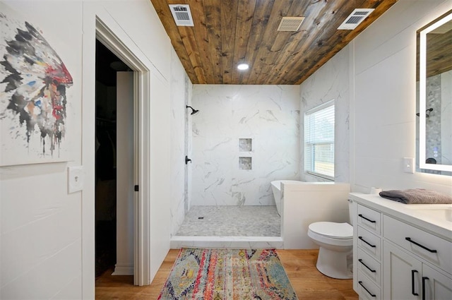 bathroom featuring vanity, tiled shower, hardwood / wood-style flooring, wooden ceiling, and toilet