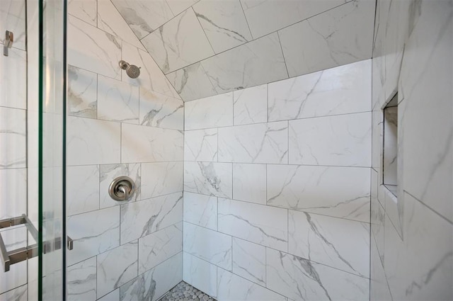 bathroom with a tile shower