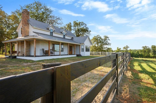 view of front of property with covered porch and a front yard