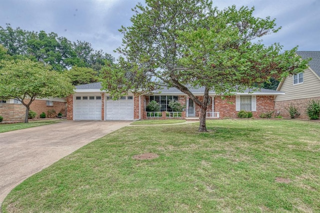 view of front of home with a front yard and a garage