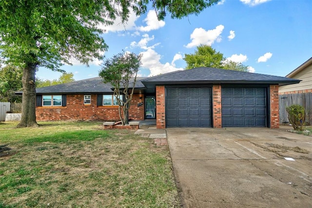 single story home featuring a front yard and a garage