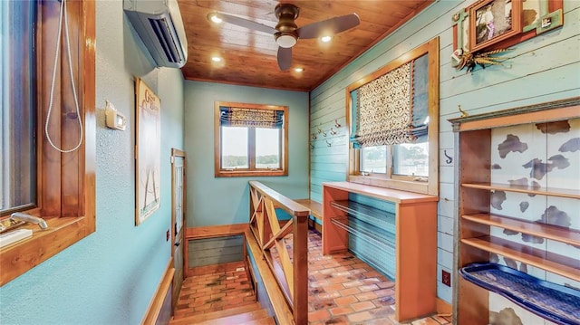 corridor featuring wood walls, a healthy amount of sunlight, wood ceiling, and a wall mounted AC