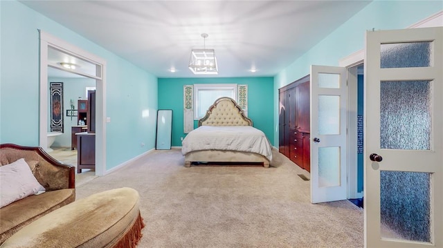 carpeted bedroom with ensuite bathroom