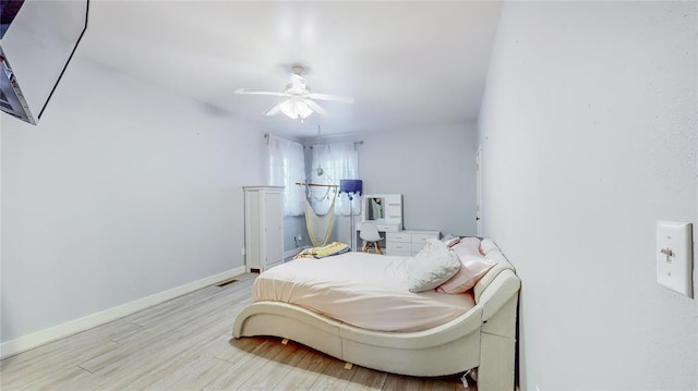 bedroom with light wood-type flooring and ceiling fan