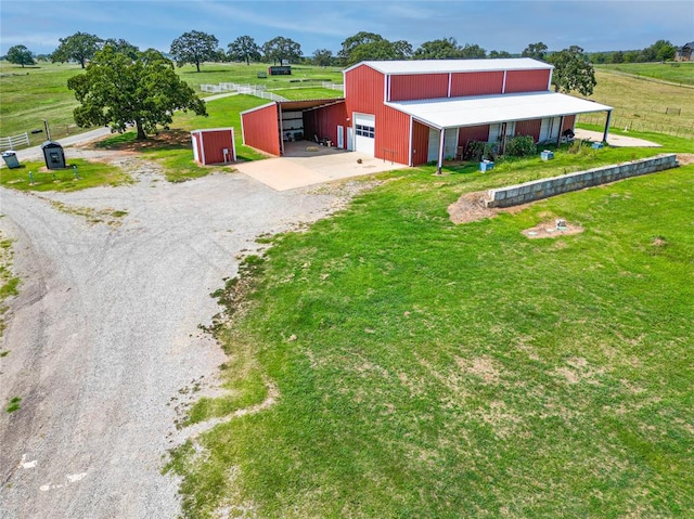 view of front facade with a rural view and an outbuilding