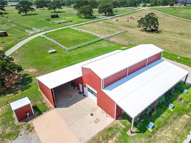 birds eye view of property with a rural view