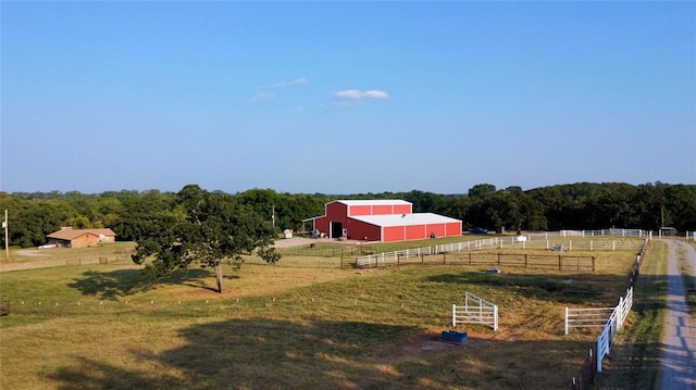 view of yard with a rural view and an outdoor structure