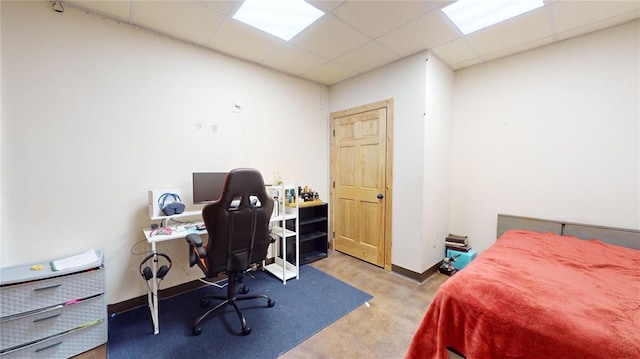 bedroom featuring a paneled ceiling and light colored carpet