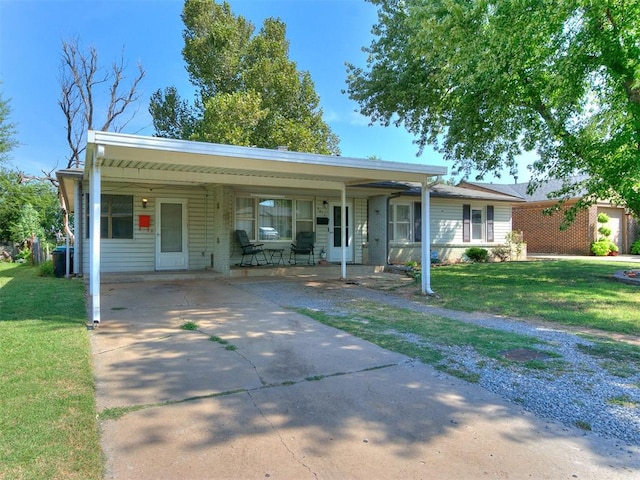 single story home with a front yard and a carport