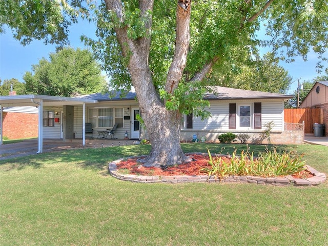 ranch-style house featuring a carport and a front lawn