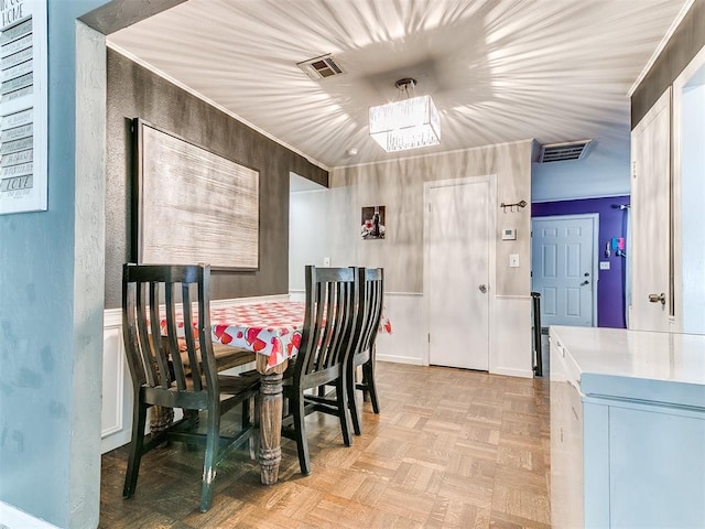 dining room featuring an inviting chandelier and light parquet floors