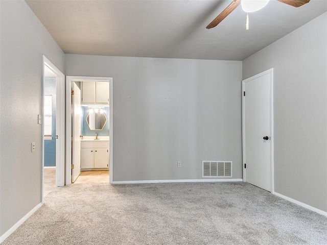 carpeted spare room with ceiling fan and sink