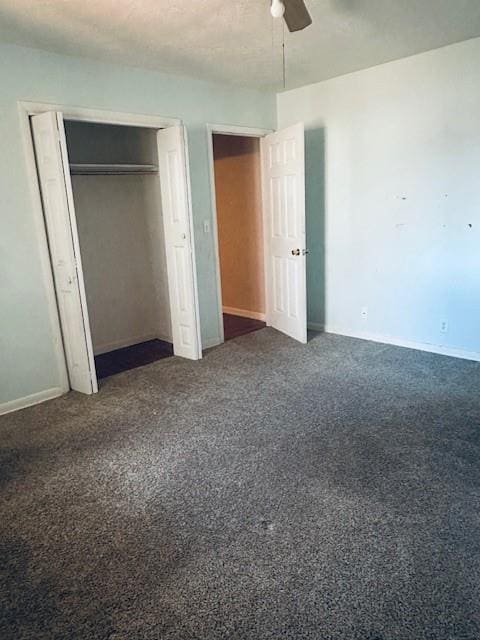 unfurnished bedroom featuring ceiling fan and dark colored carpet