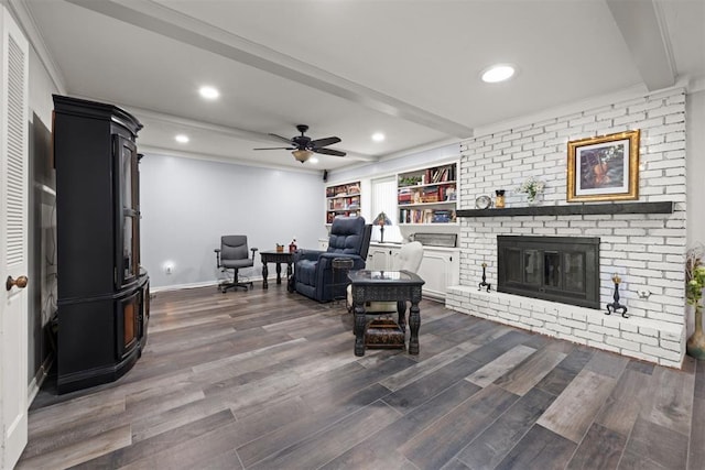 living room featuring ornamental molding, a brick fireplace, ceiling fan, and dark wood-type flooring