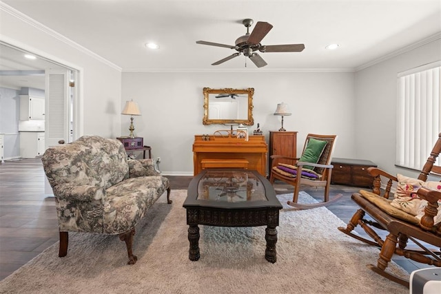 living room featuring ceiling fan, ornamental molding, and dark wood-type flooring