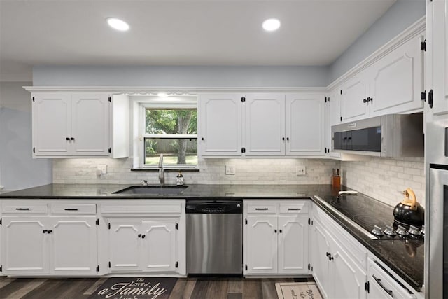 kitchen with white cabinets, sink, and appliances with stainless steel finishes