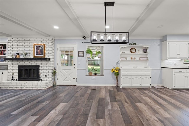 interior space featuring decorative light fixtures, white cabinetry, and dark wood-type flooring