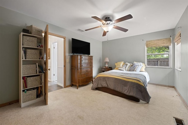 bedroom featuring light colored carpet and ceiling fan