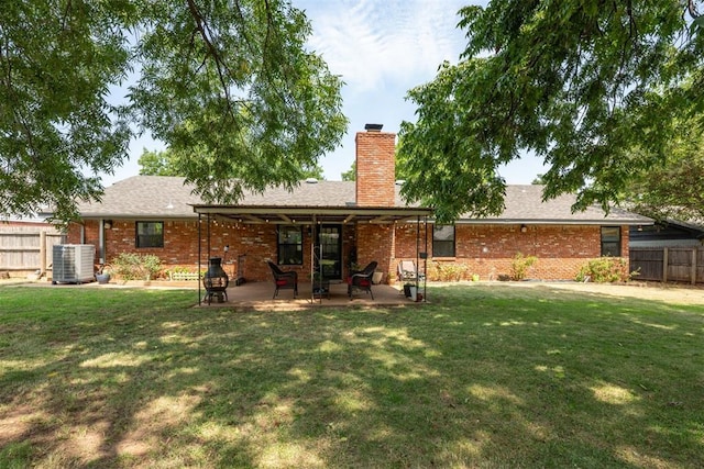 back of house featuring a yard, a patio area, and central air condition unit