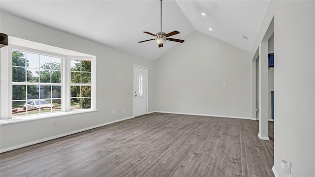 unfurnished living room featuring ceiling fan, light hardwood / wood-style floors, and high vaulted ceiling