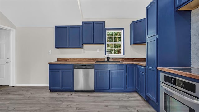 kitchen featuring blue cabinetry, appliances with stainless steel finishes, and sink