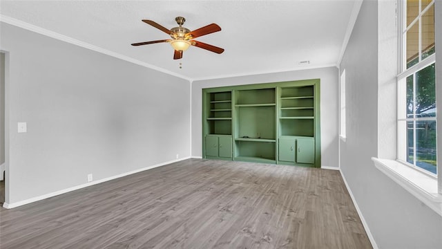 interior space featuring hardwood / wood-style flooring, ceiling fan, and ornamental molding