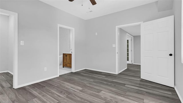 spare room featuring dark hardwood / wood-style floors and ceiling fan