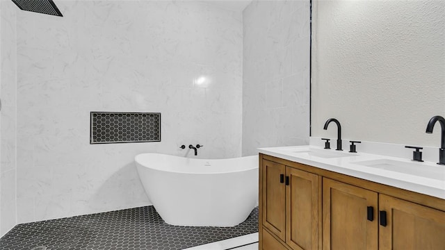 bathroom featuring vanity and a tub